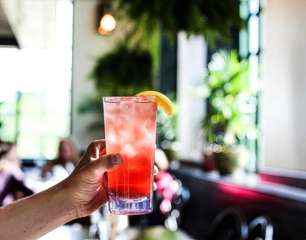 Hand holding up craft cocktail