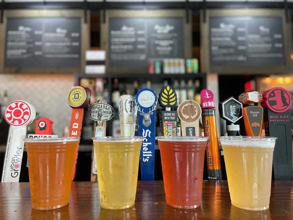 Craft beers in front of taps and menu board