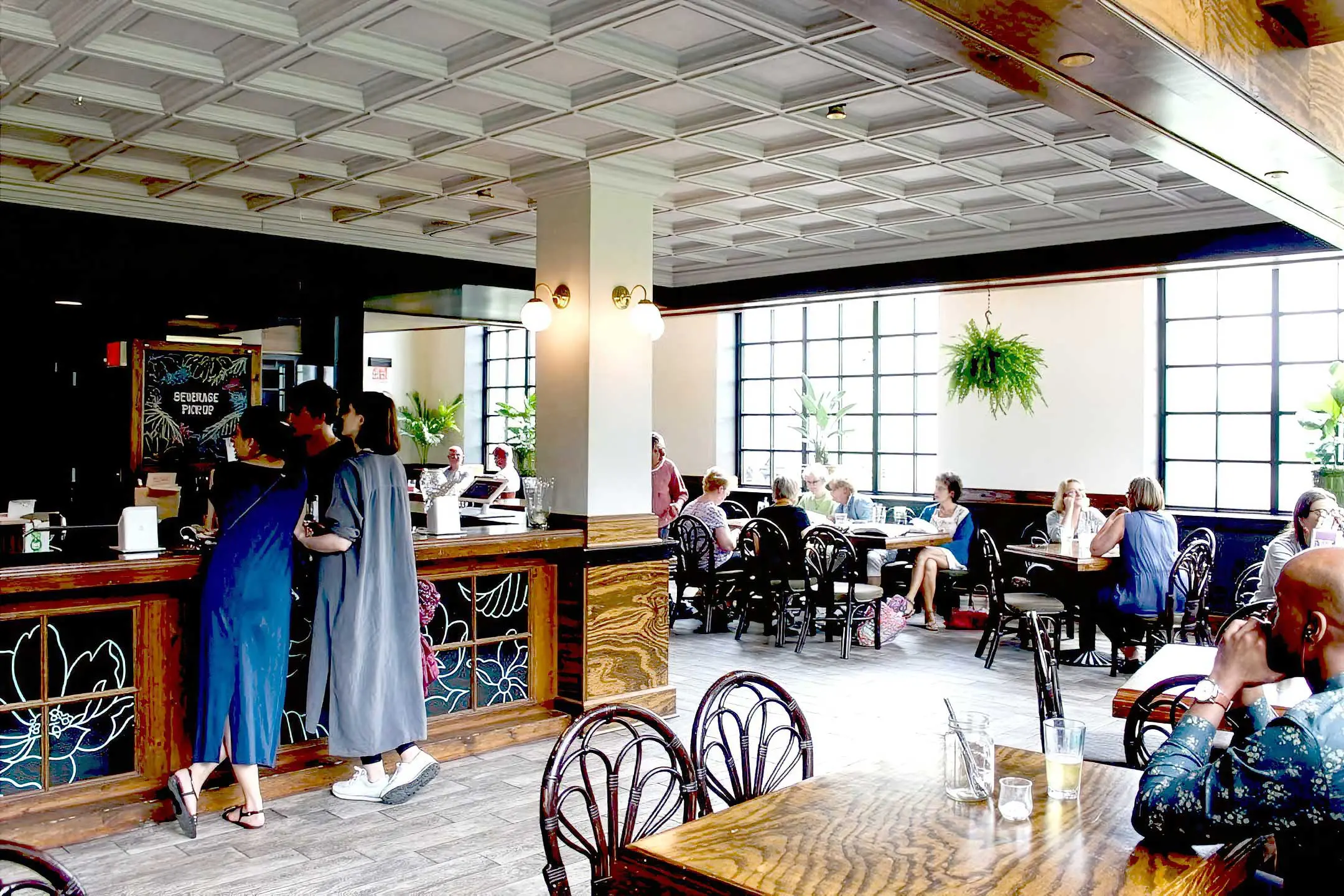Interior of Dock & Paddle with guest ordering at register and tables filled with customers